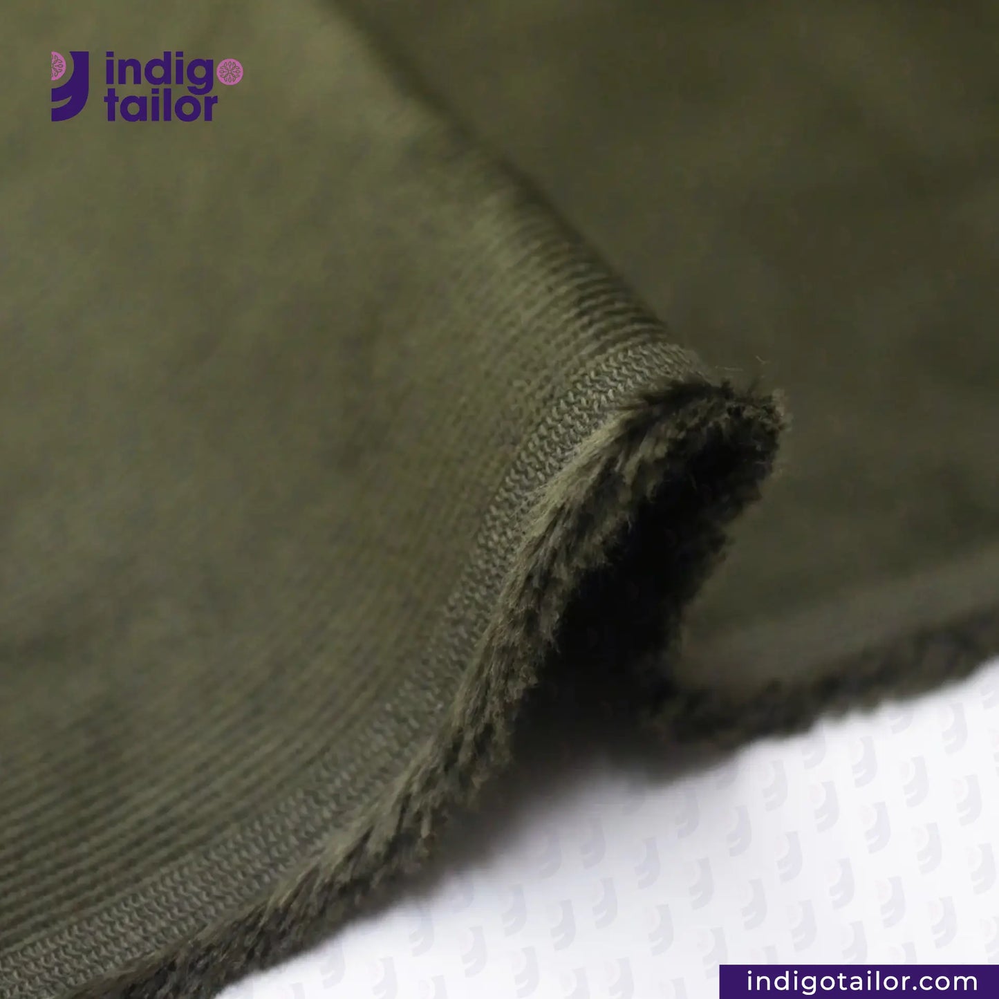 Close-up of OLIVE CORDUROY fabric with 'Indigo Tailor' branding.