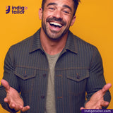 Man wearing a OLIVE WABASH SELVEDGE DENIM jacket with Indigotailor logo on yellow background