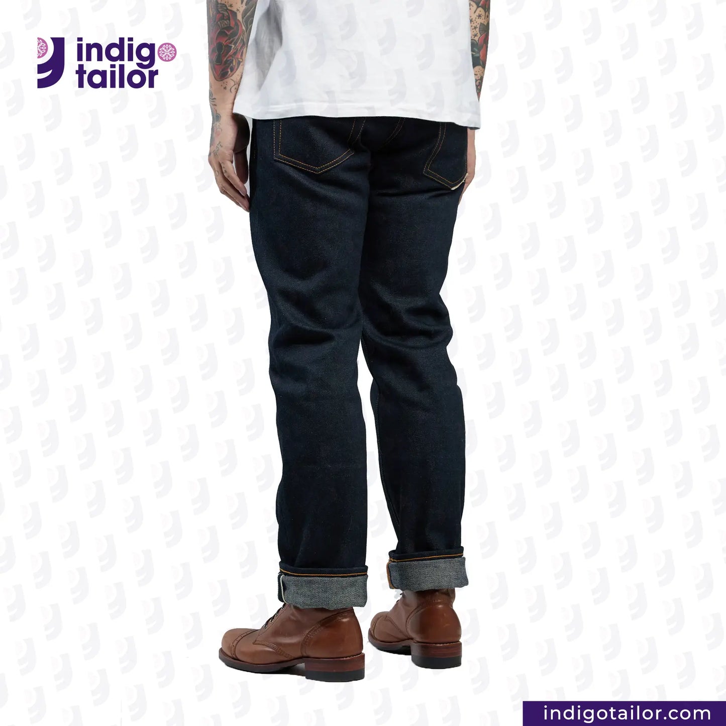 Person wearing dark blue jeans and brown boots with 'Indigo Tailor' logo and website URL on a white background.