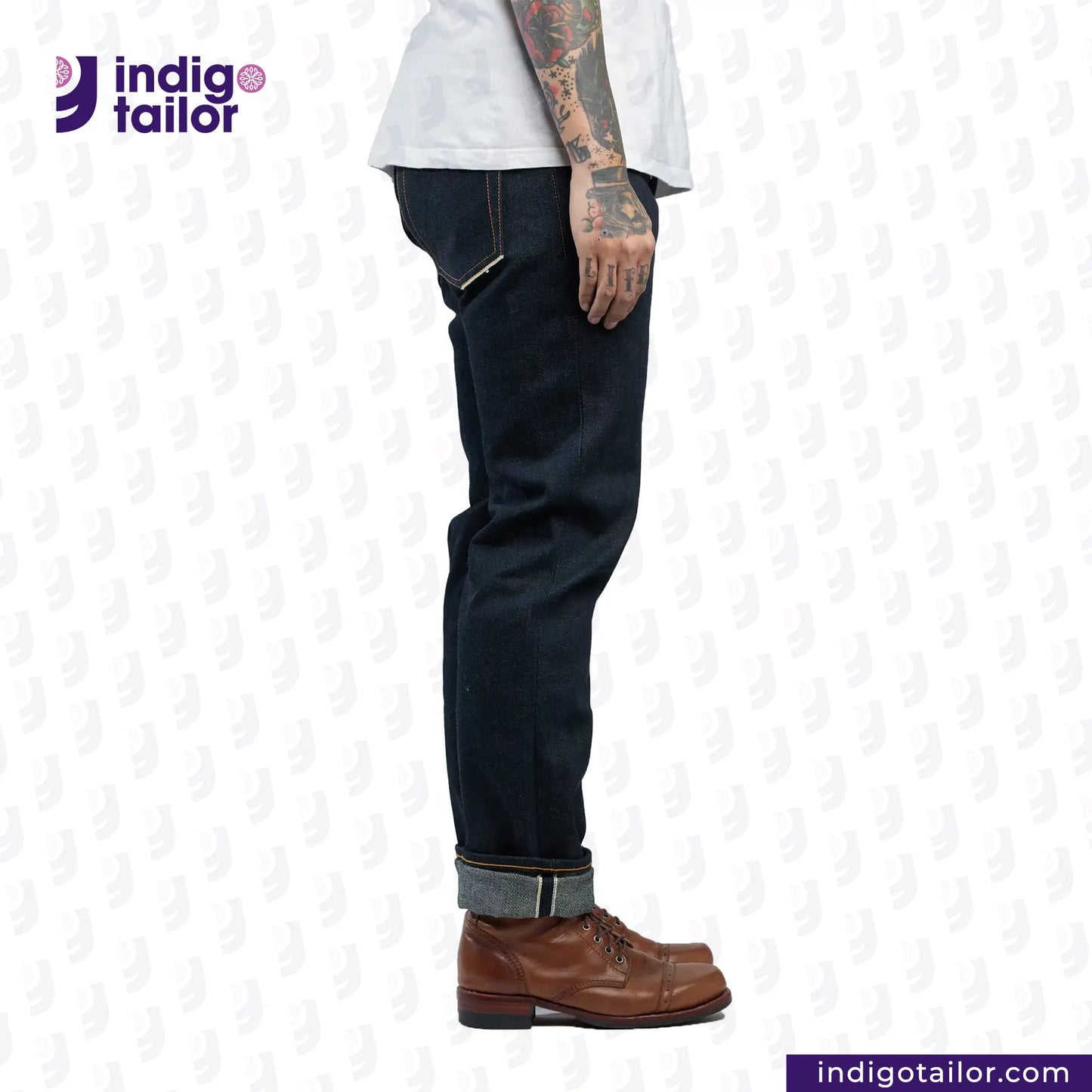 Person wearing dark jeans and brown boots with 'Indigotailor' logo on a white background