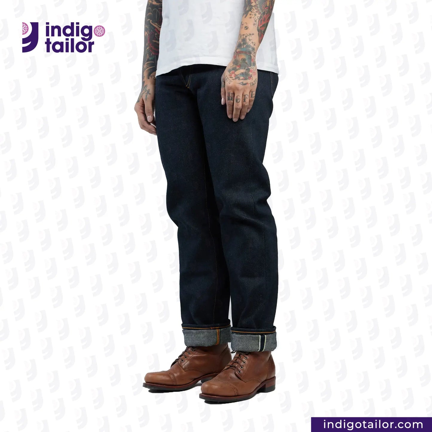 Person wearing dark blue jeans and brown shoes on a white background with 'Indigo Tailor' branding.