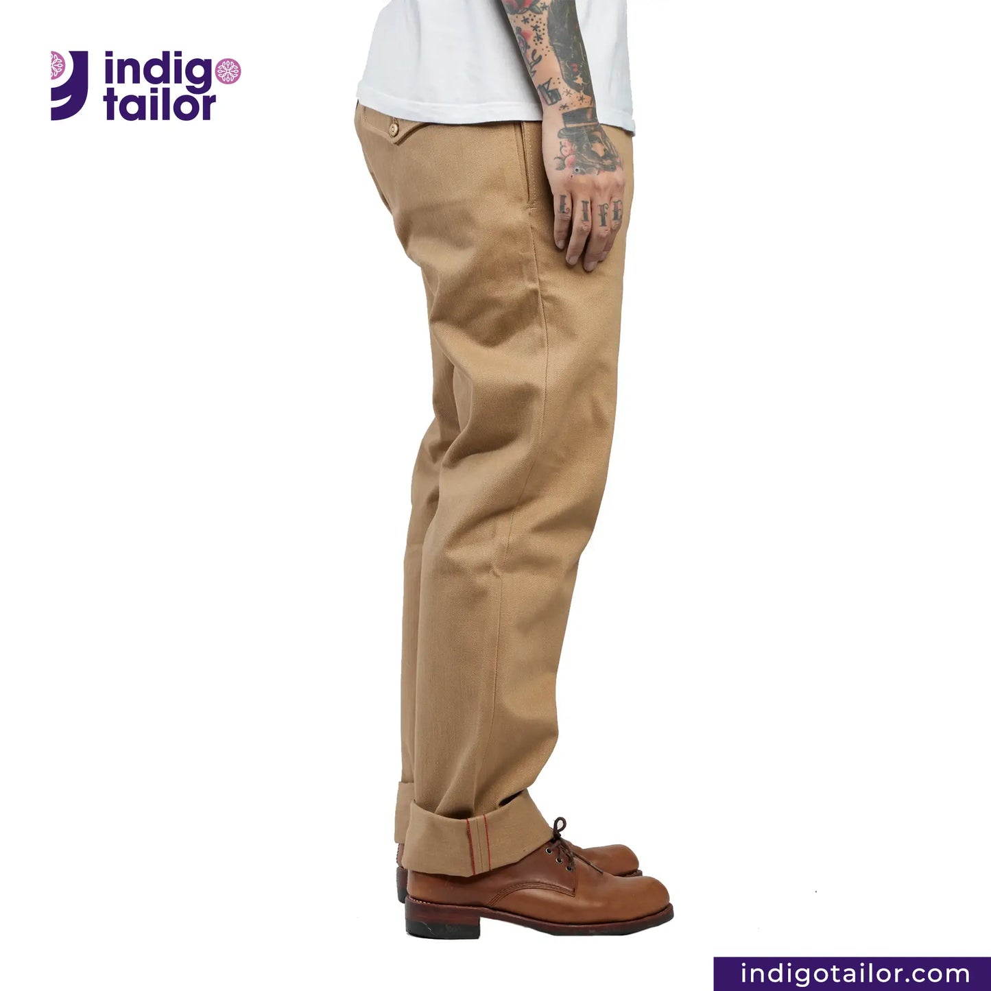 Person wearing Officer Trousers (Khaki) pants with 'indigotailor' logo on a white background