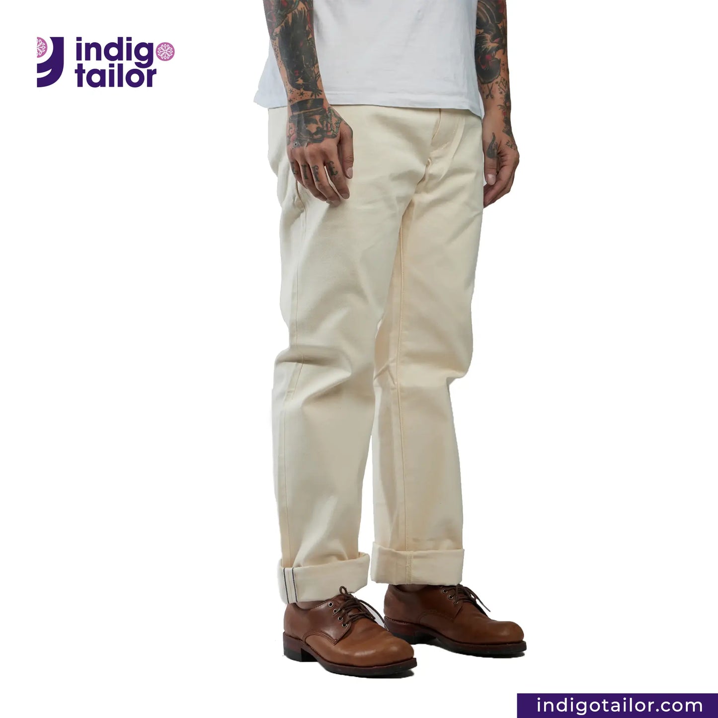 Person wearing Officer Trousers (Off-White) pants and brown shoes with 'Indigo Tailor' logo and website URL.