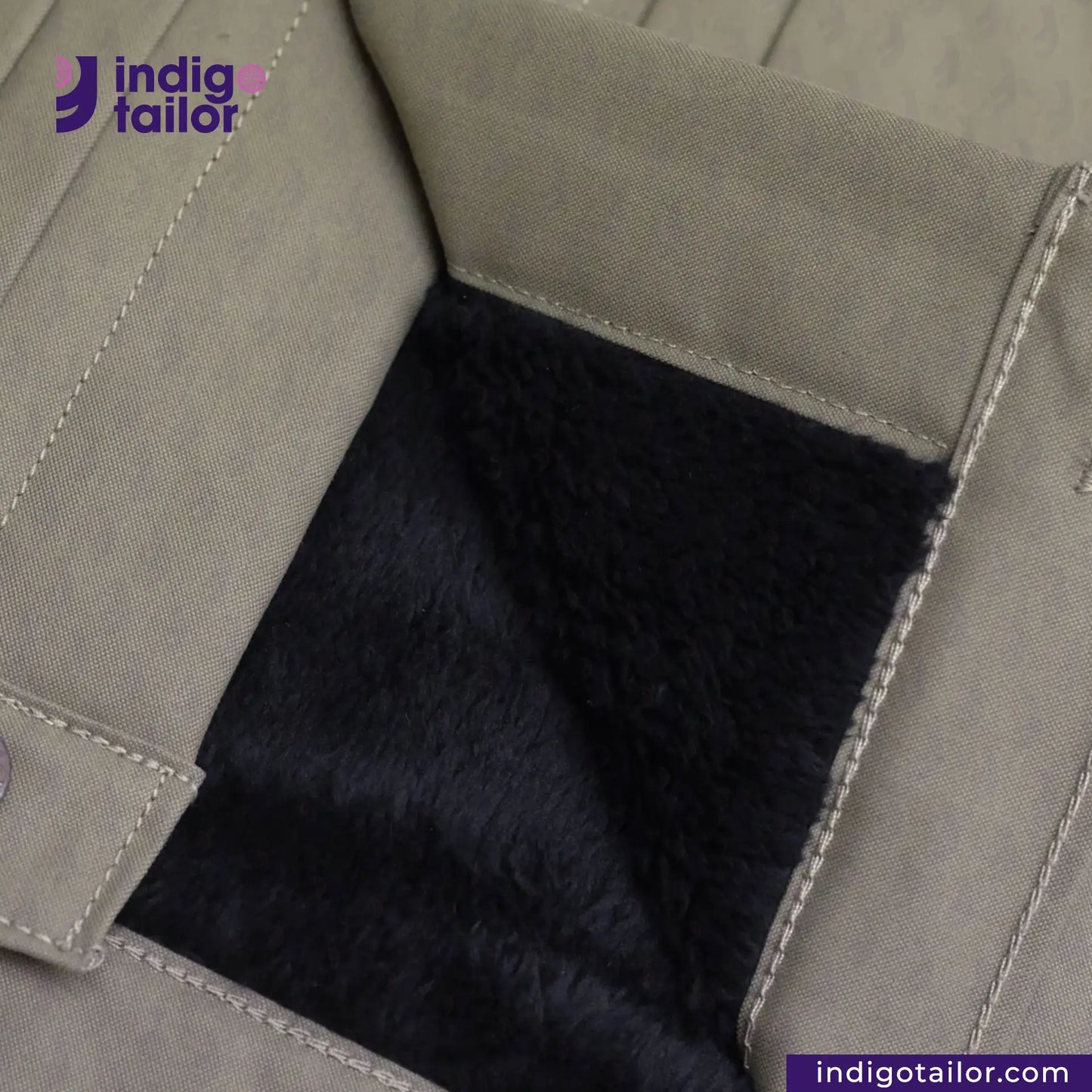 Close-up of a SHERPA LINED WAXED CANVAS TRUCKER JACKET with black fur lining, featuring the Indigotailor logo.