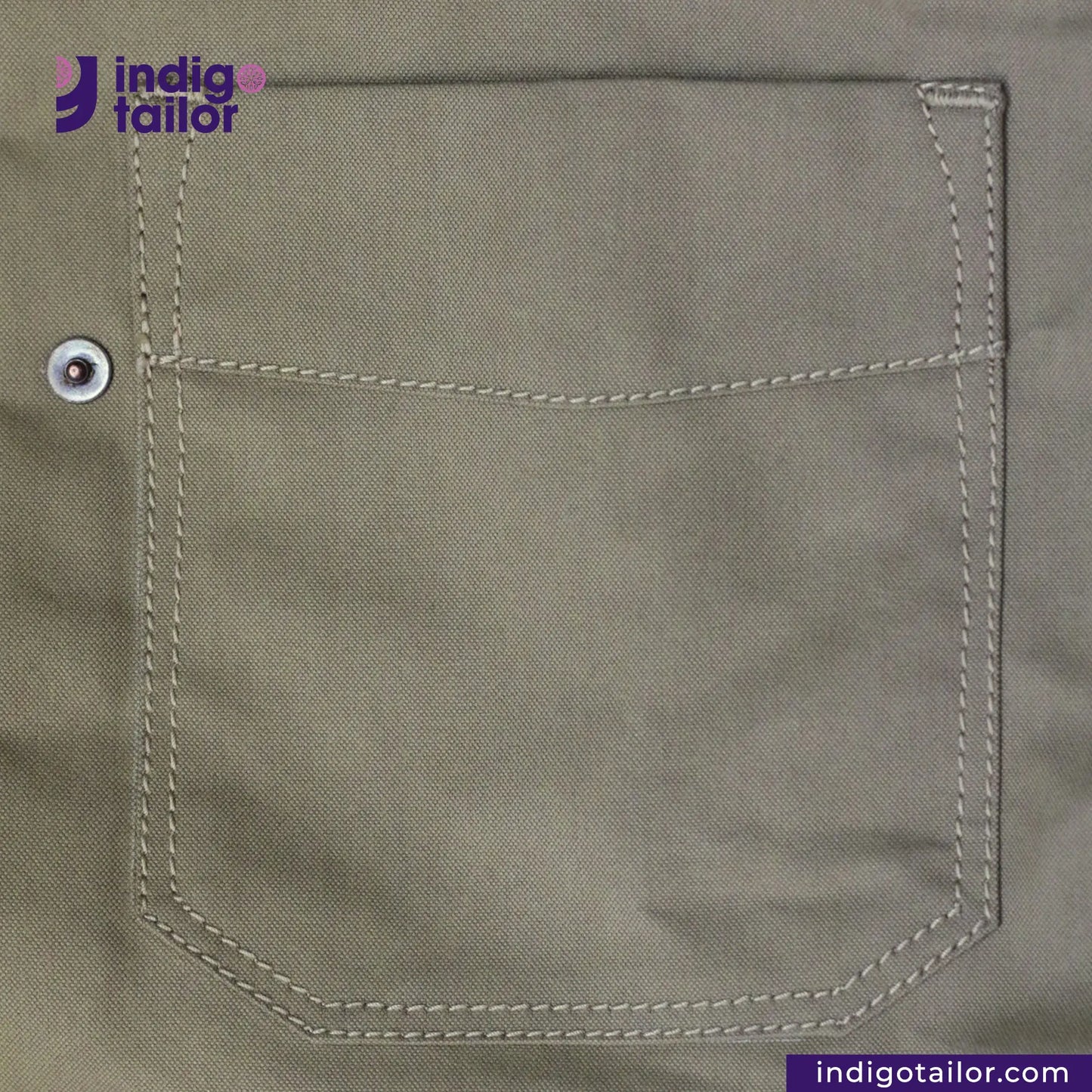 Close-up of a pocket on a SHERPA LINED WAXED CANVAS TRUCKER JACKET with 'Indigotailor' branding.