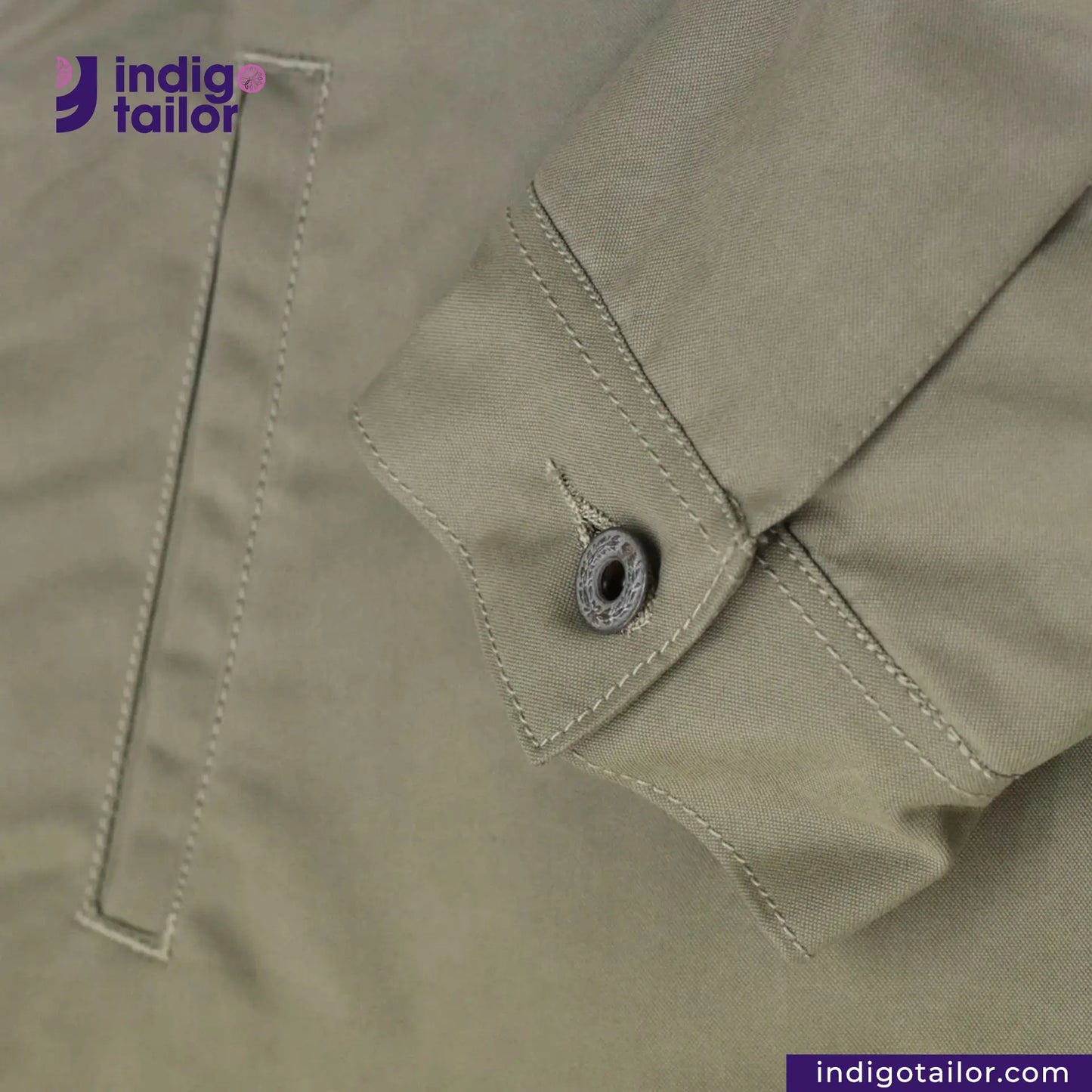 Close-up of a button on a SHERPA LINED WAXED CANVAS TRUCKER JACKET with 'Indigotailor' branding.