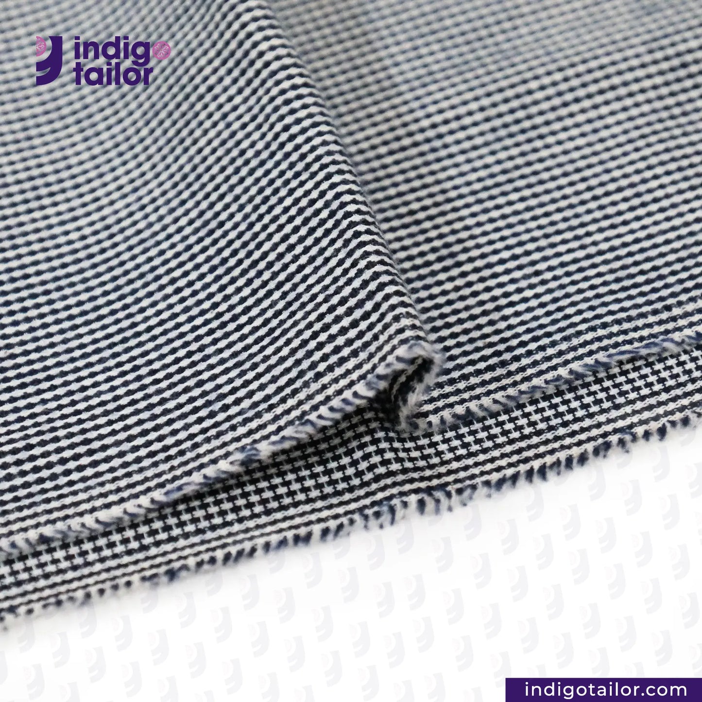 Close-up of SUMMER SASHIKO DOBBY fabric with 'Indigotailor' logo.