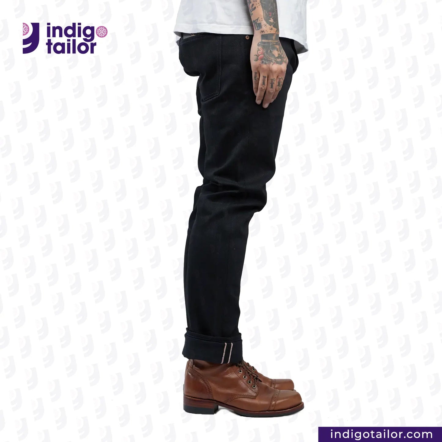 Person wearing SUPER BLACK DENIM pants and brown boots with 'Indigo Tailor' logo and website URL on a white background.