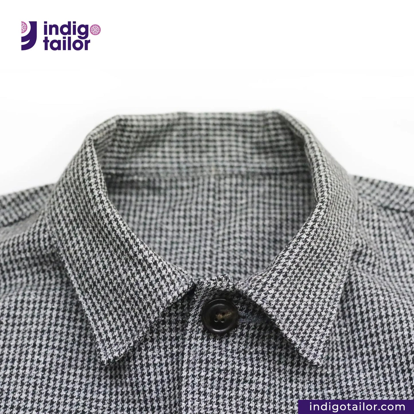 Close-up of a TWEED HOUNDSTOOTH COVERALL JACKET checkered collar with 'Indigotailor' logo.