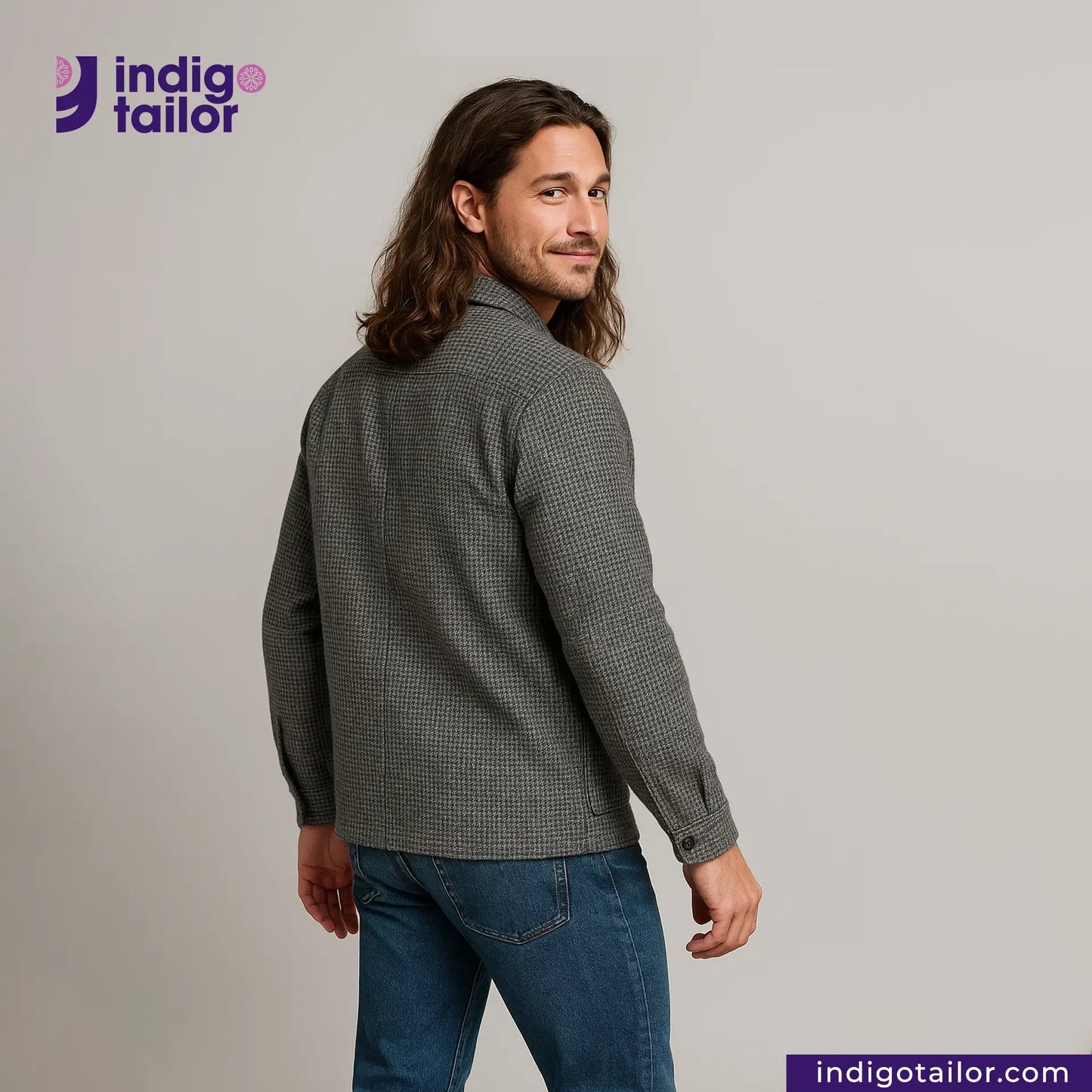 Man wearing a TWEED HOUNDSTOOTH COVERALL JACKET shirt and blue jeans with 'Indigo Tailor' logo and website on a gray background