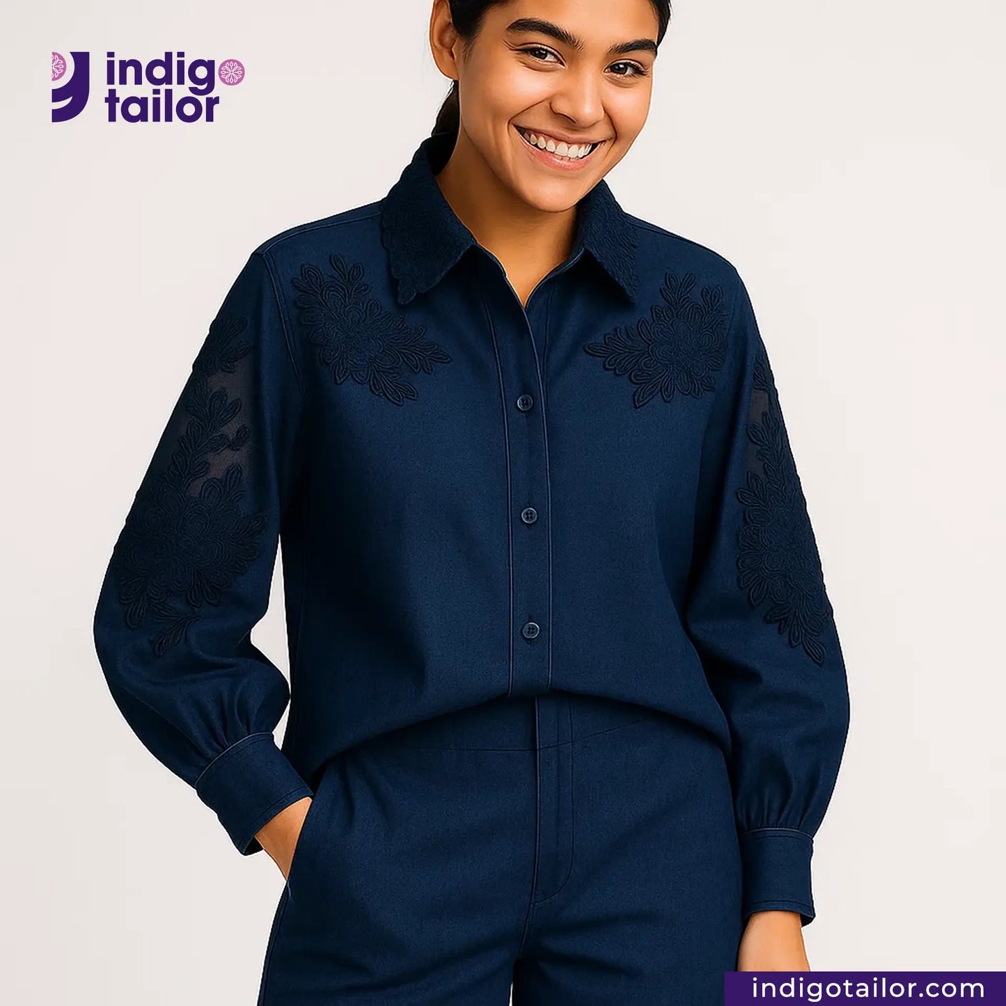 Woman wearing a TWO TONE SELVEDGE PAPER WEIGHT DENIM embroidered shirt and pants with 'Indigo Tailor' logo.