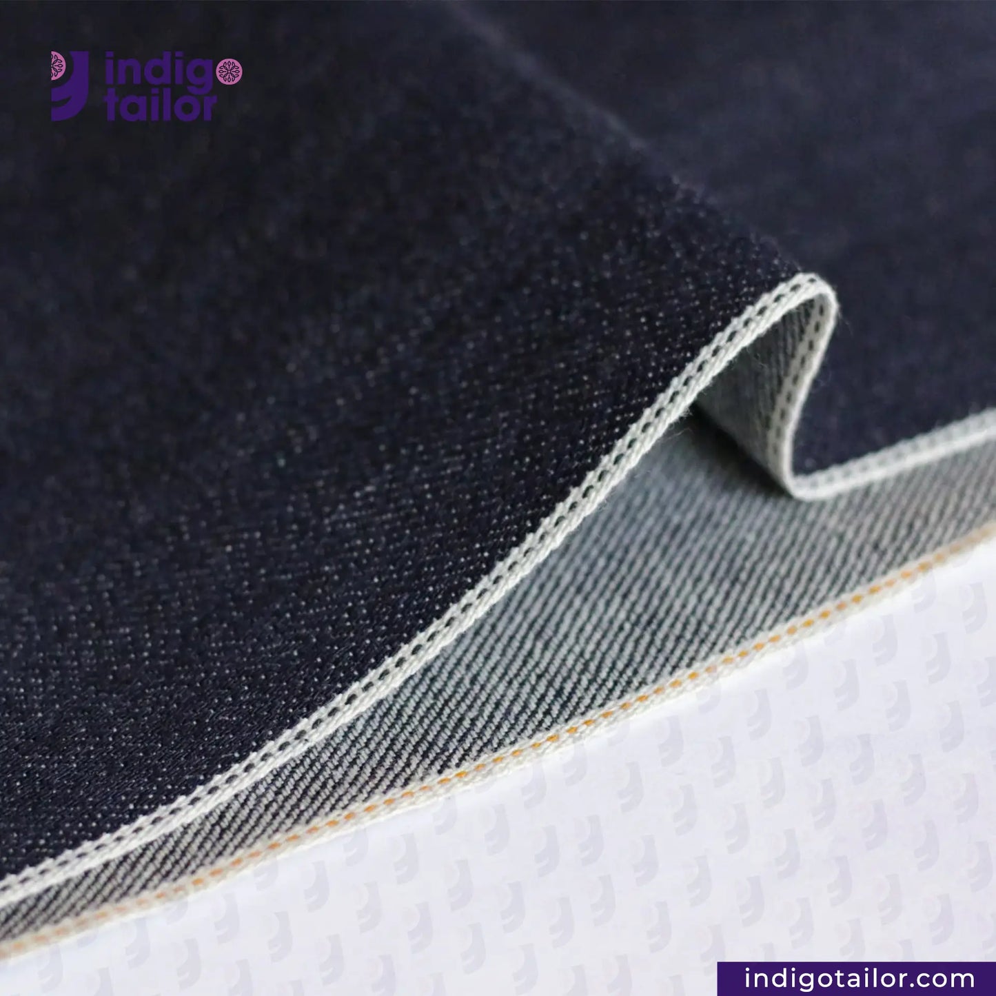 Close-up of TWO TONE SELVEDGE PAPER WEIGHT DENIM fabric with 'Indigotailor' branding.