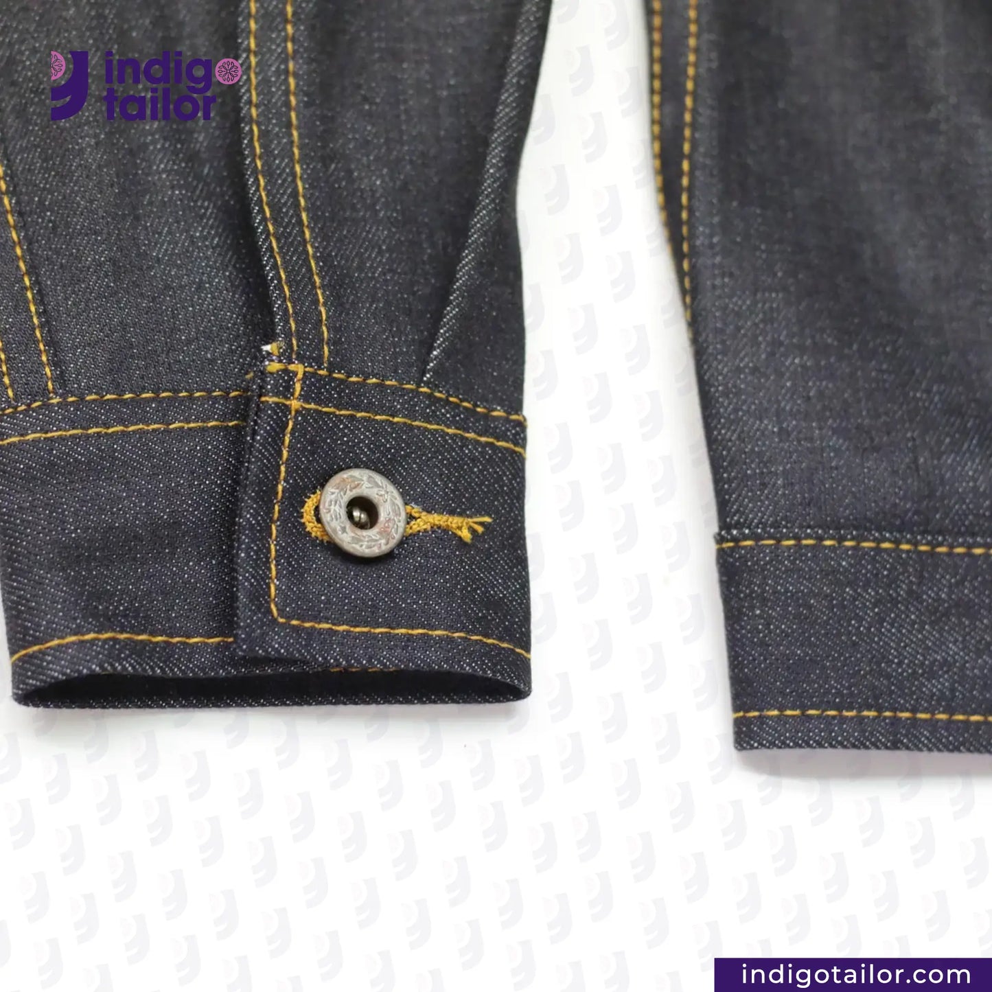 Close-up of a button on a TYPE 1 JACKET with 'Indigotailor' branding.