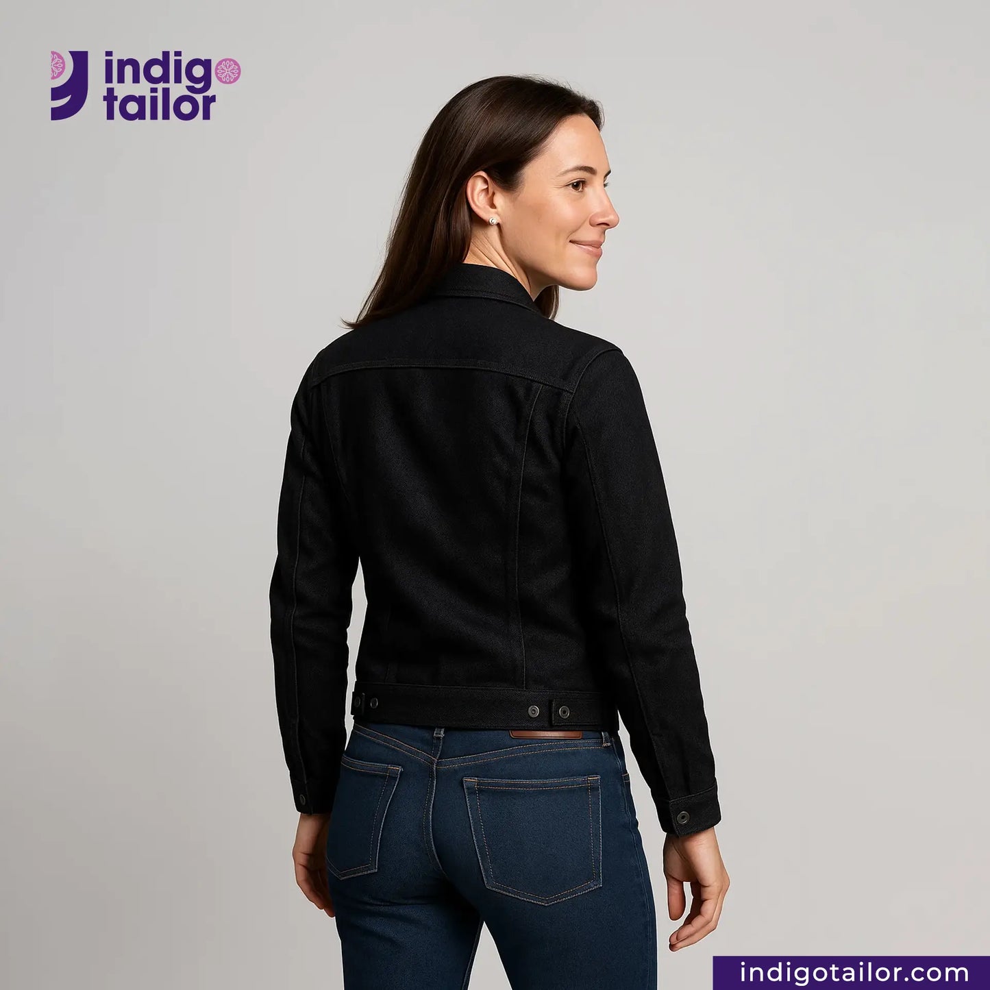 Woman wearing a TYPE III DOUBLE BLACK TRUCKER JACKET and blue jeans with 'Indigotailor' branding.
