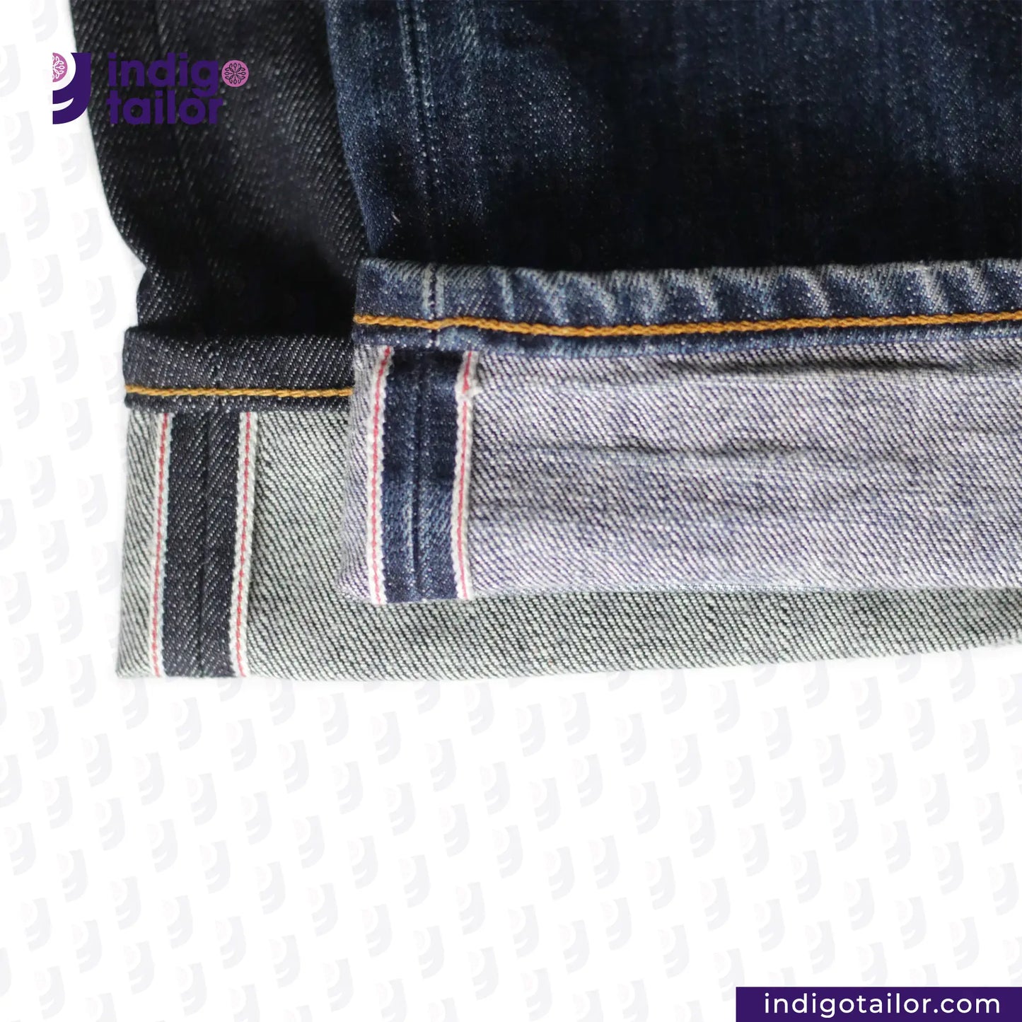 Close-up of VINTAGE SLUB DENIM jeans with a brand logo in the corner