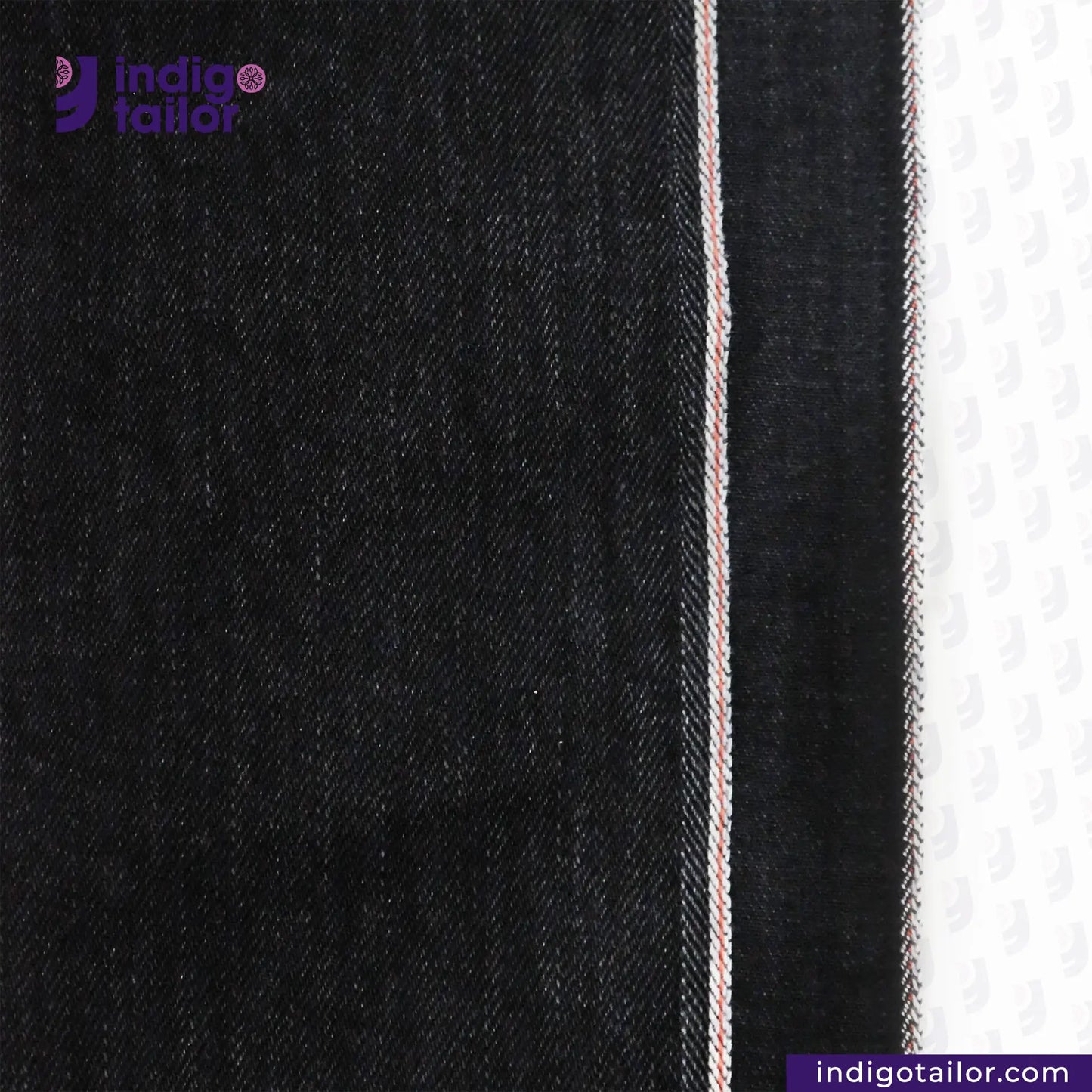Close-up of WASHED BLACK x BLACK SELVEDGE DENIM fabric with a visible brand logo and website text.