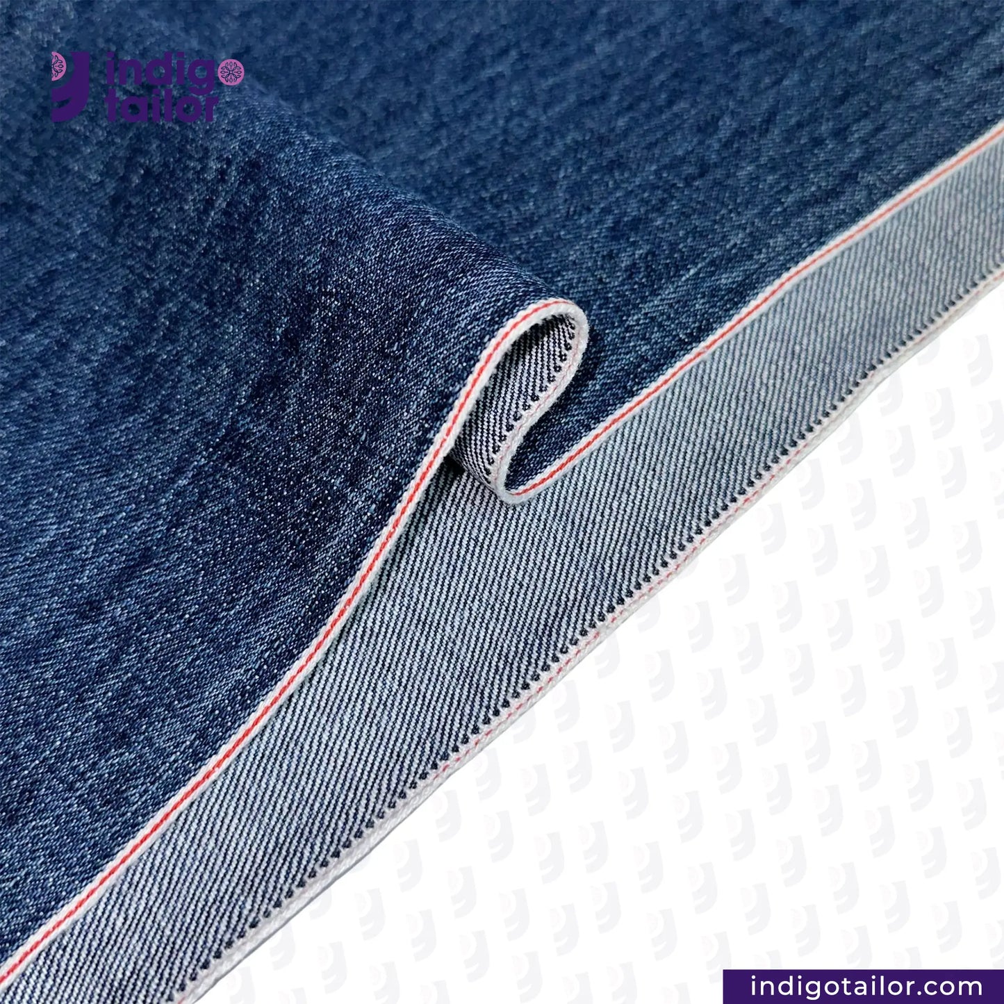 Close-up of WASHED VINTAGE SLUB SELVEDGE DENIM fabric with a visible brand logo on a white background