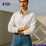 Woman wearing a WHITE DENIM NAVY SELVEDGE shirt and blue jeans with 'Indigotailor' branding.