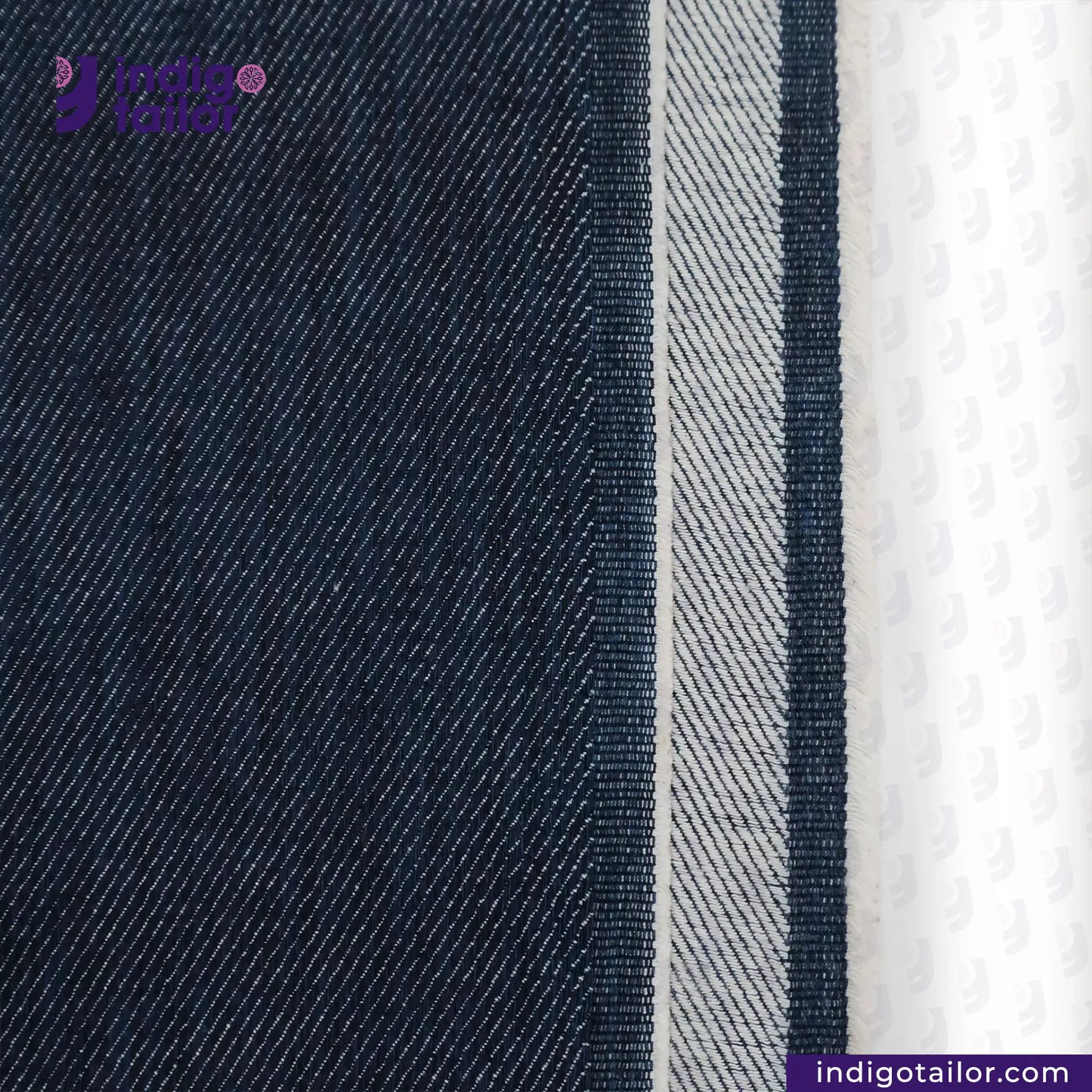 Close-up of WILD INDIGO denim fabric with a brand logo and website text.