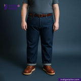 Person wearing WILD INDIGO jeans and brown shoes on a dark background with 'Indigo Tailor' branding.