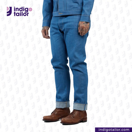 Person wearing AOZORA SKY BLUE DENIM jeans and brown shoes with 'Indigo Tailor' logo.