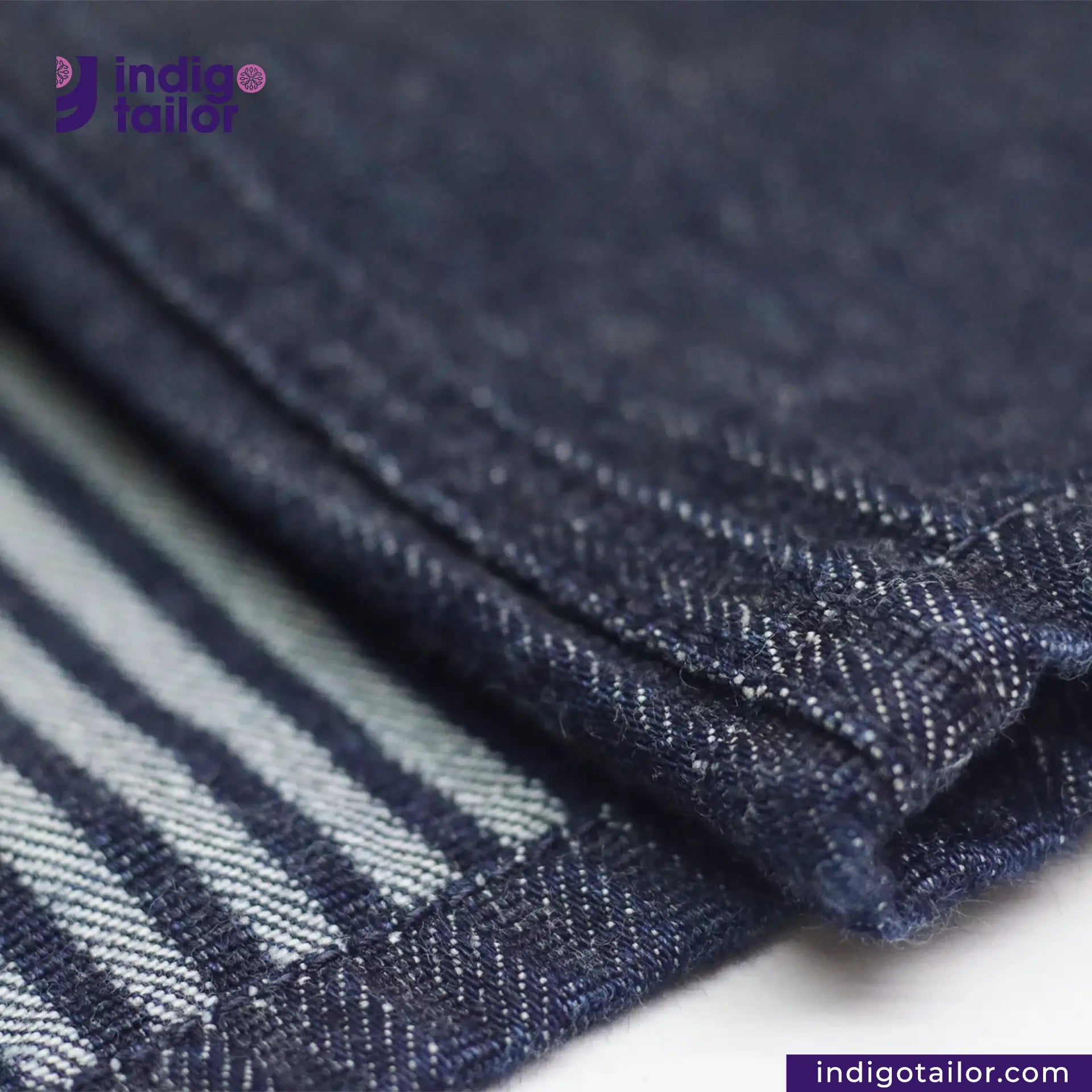 Close-up of BASEBALL NORAGI (DARK INDIGO) denim fabric with 'Indigotailor' branding.