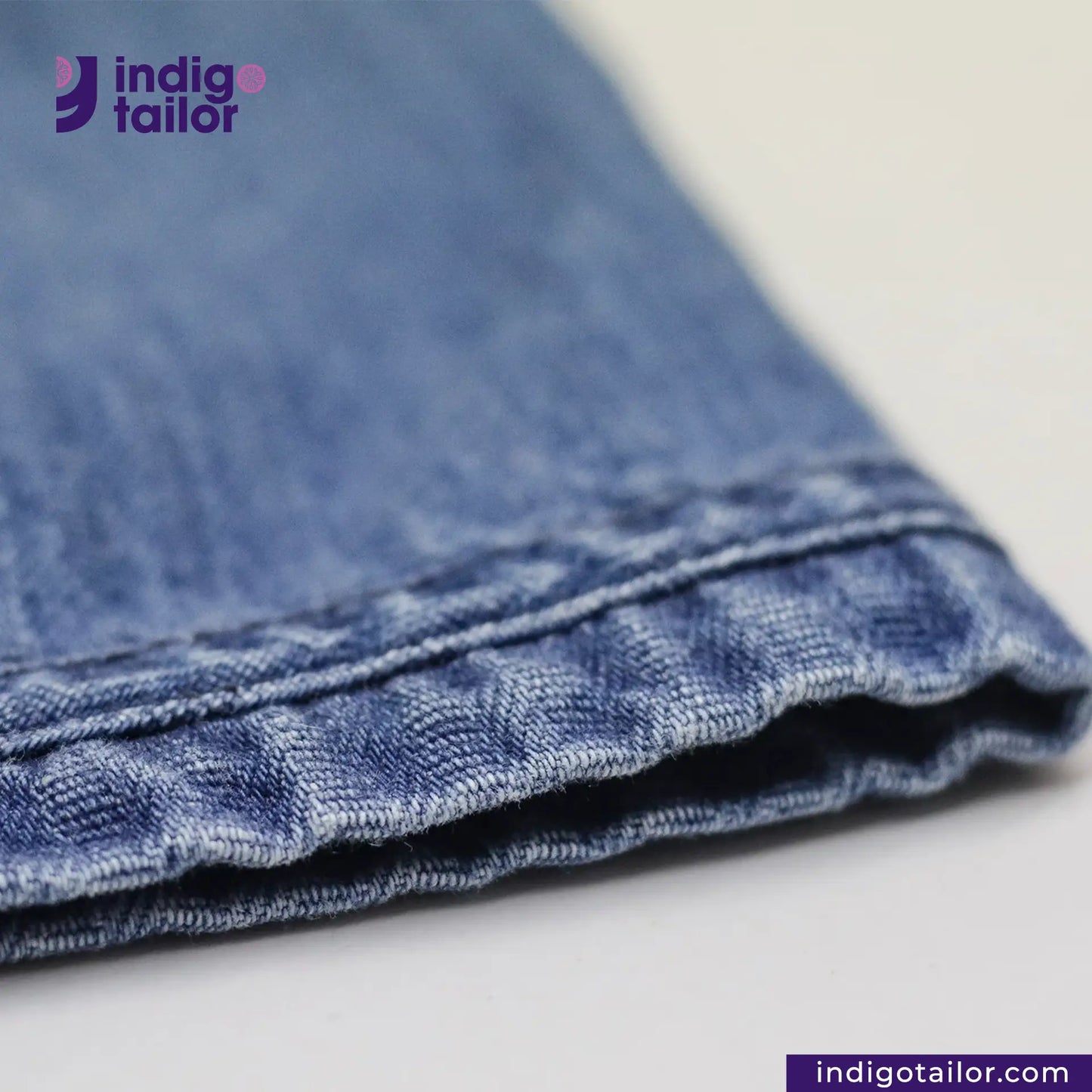 Close-up of BASEBALL NORAGI (VINTAGE BLUE) with 'indigotailor' logo and website on a light background