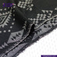 Close-up of BLACK NATIVE AMERICAN JACQUARD fabric with geometric pattern, branded 'Indigo Tailor'.