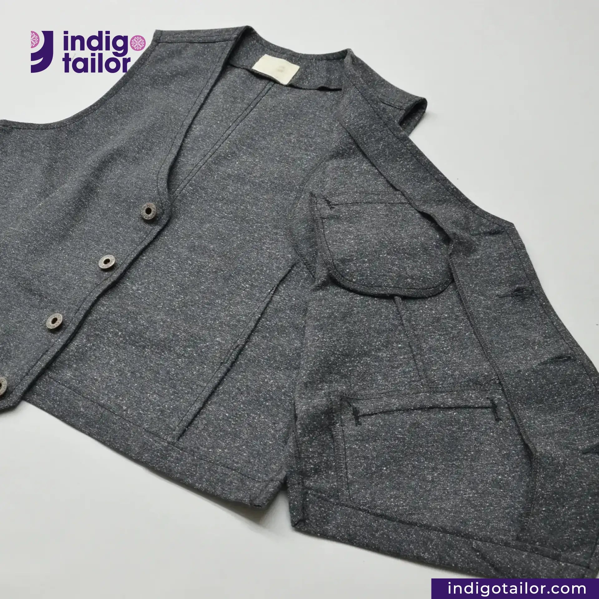 BLACK TWEED WORK VEST with a brand logo on a light gray background