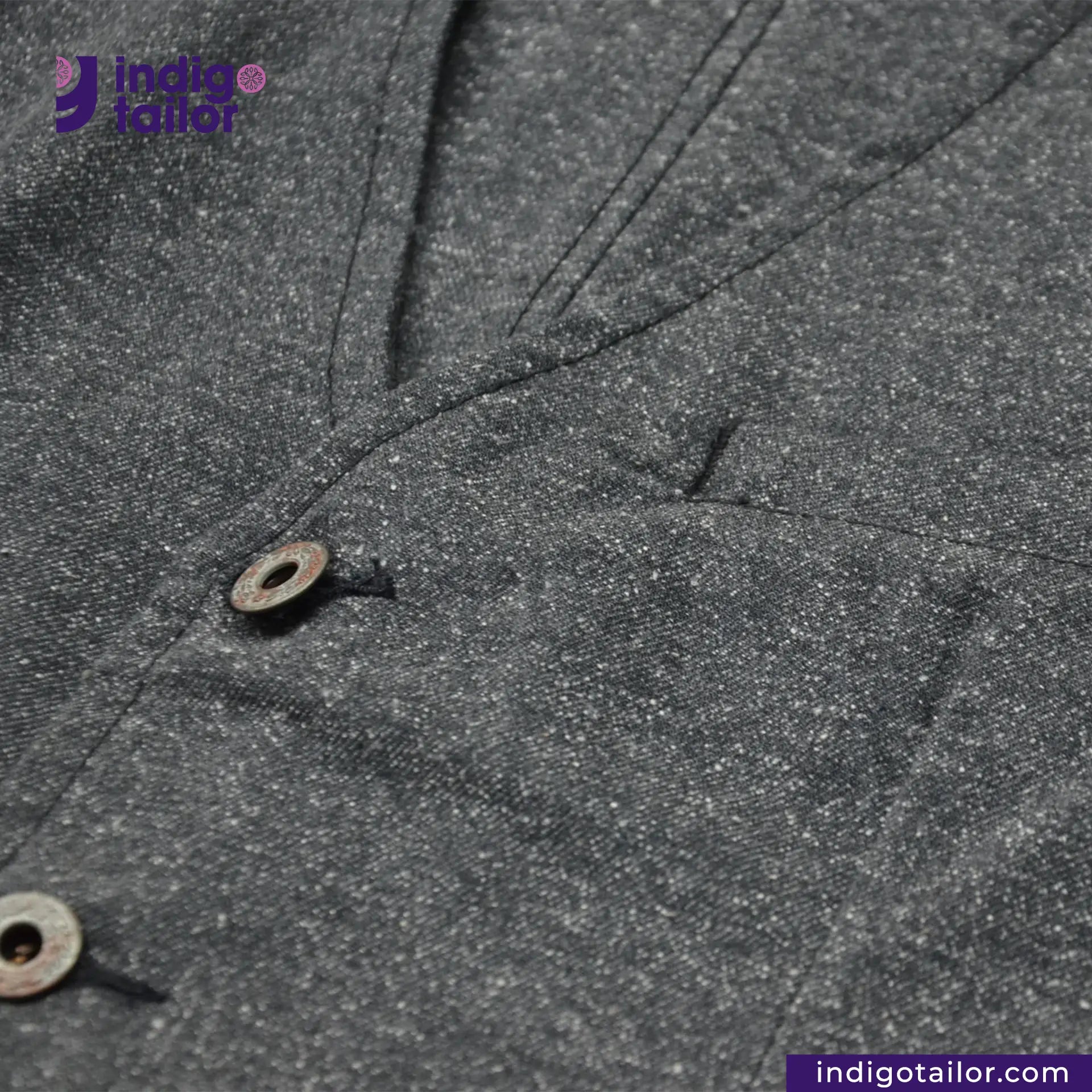 Close-up of BLACK TWEED WORK VEST with a button, featuring Indigotailor logo.