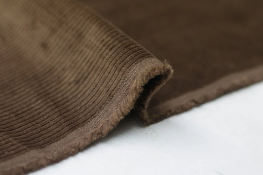Close-up of BROWN CORDUROY fabric on a white background