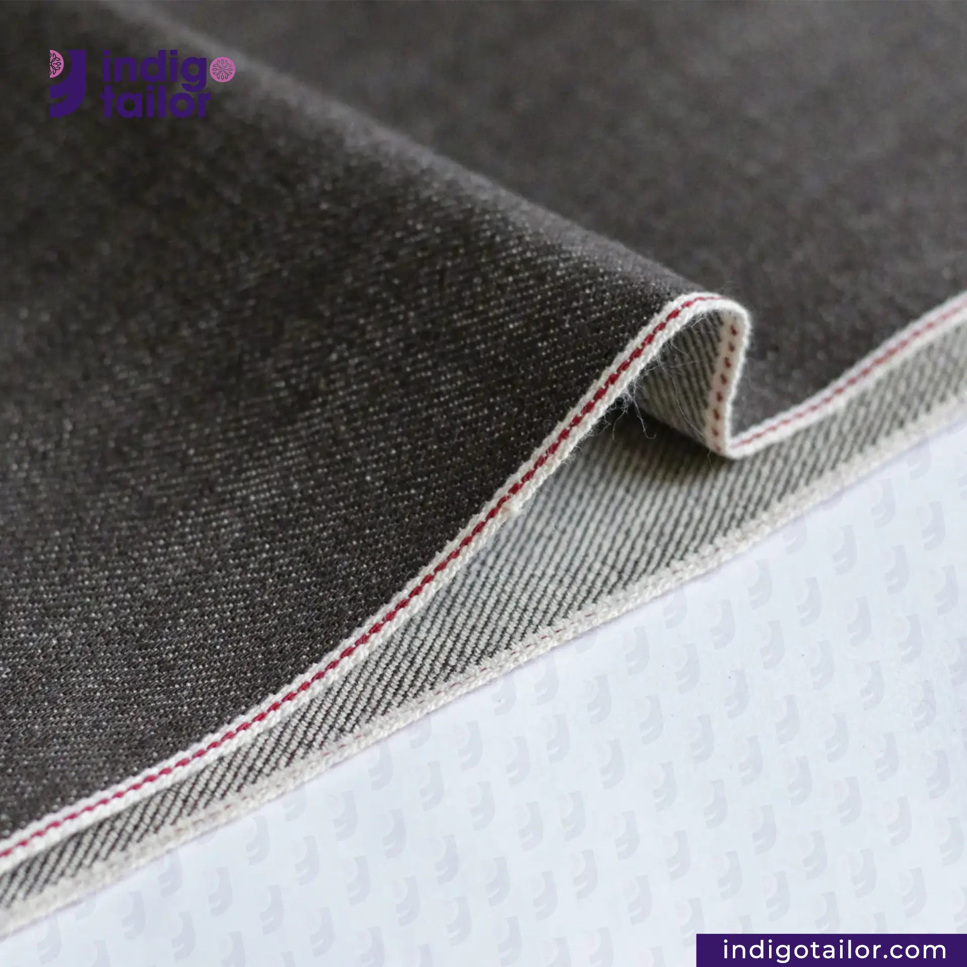 Close-up of BROWN SOFT SLUB SELVEDGE DENIM fabric with a brand logo in the corner
