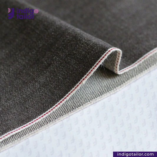 Close-up of BROWN SOFT SLUB SELVEDGE DENIM fabric with a brand logo in the corner