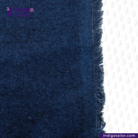 Close-up of BRUSHED INDIGO VIBRANT BLUE fabric with a visible brand logo on a white background