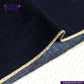 Close-up of BULLION GOLD SELVEDGE DENIM fabric with gold trim on a white background, featuring the Indigotailor logo.