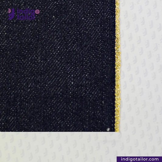 BULLION GOLD SELVEDGE DENIM fabric with a gold thread on a white background, featuring the Indigo Tailor logo.