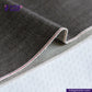 Close-up of gray denim fabric with a visible brand logo and website. Brown SOFT SLUB SELVEDGE DENIM