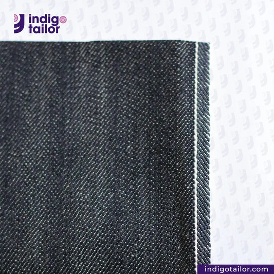 Close-up of CLASSIC BLACK SELVEDGE DENIM fabric with 'Indigo Tailor' logo and website URL.