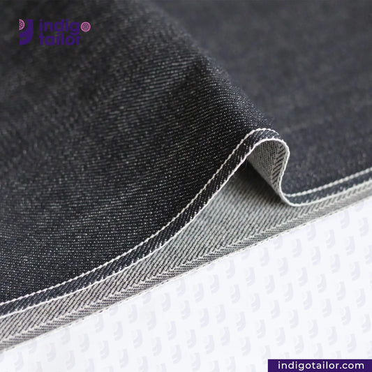 Close-up of CLASSIC BLACK SELVEDGE DENIM fabric with 'Indigotailor' branding.