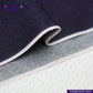 Close-up of CLASSIC BLUE SELVEDGE DENIM fabric with visible stitching, featuring the Indigo Tailor logo.