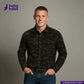 Man wearing a CORD CAMO OVERSHIRT camouflage shirt with 'Indigo Tailor' logo and website on a gray background