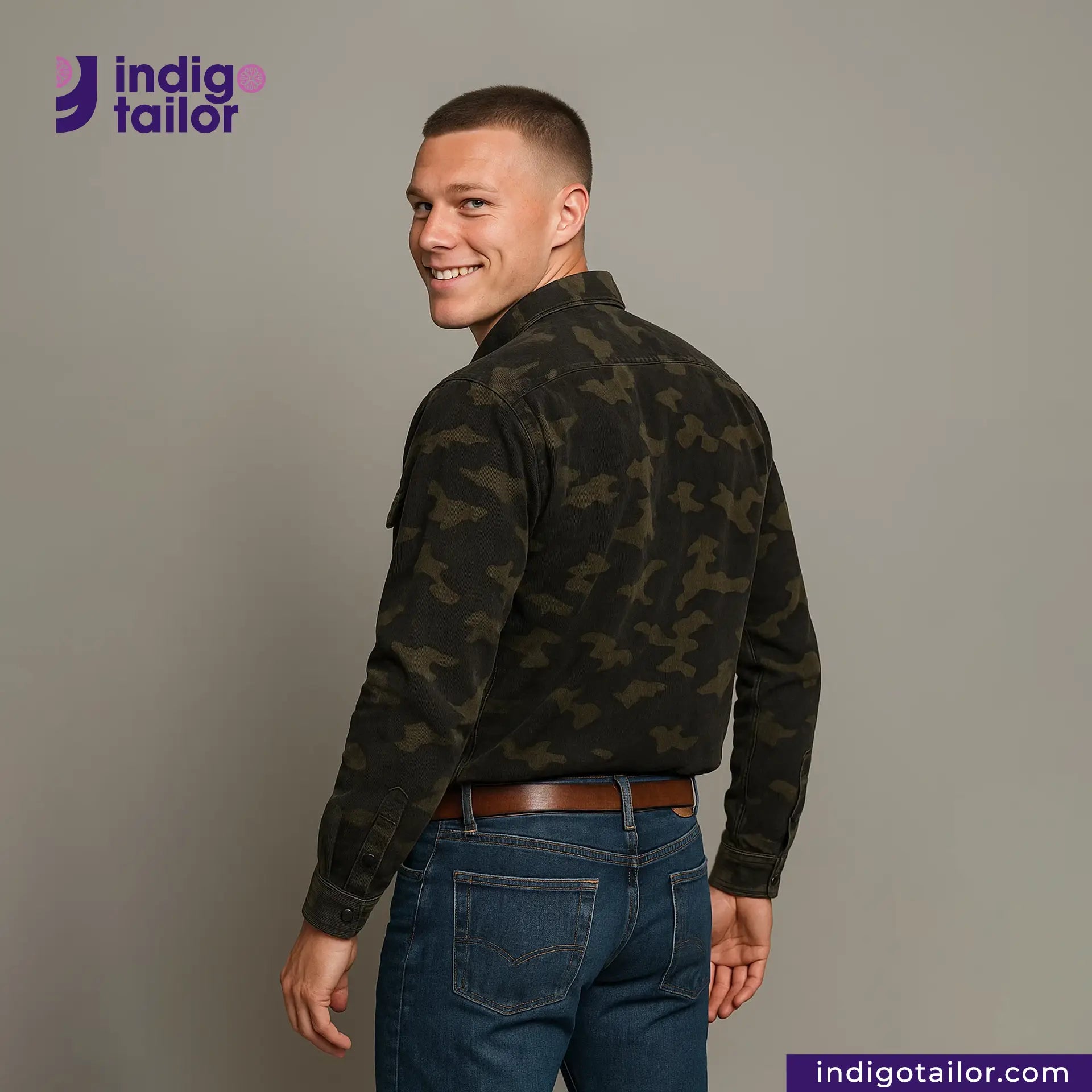 Man wearing a CORD CAMO OVERSHIRT camouflage jacket and jeans with 'Indigo Tailor' logo and website on a gray background