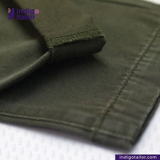 Close-up of Chino Green fabric with 'indigotailor' branding on a white background