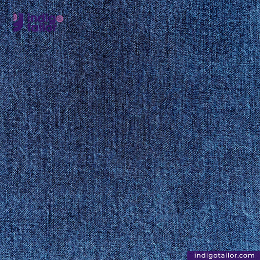 Close-up of DARK WASHED SELVEDGE DENIM LIME SELVEDGE fabric with 'Indigo Tailor' branding.