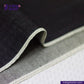 Close-up of DEEP INDIGO DOTTED BRONZE SELVEDGE fabric with 'Indigotailor' branding on a dark background