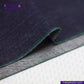 Close-up of DEEP INDIGO FOREST GREEN SELVEDGE DENIM fabric with green stitching on a white background, featuring 'Indigo Tailor' branding.