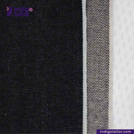 Close-up of DEEP INDIGO OMBRÉ CAST DENIM fabric with Indigotailor logo and website.