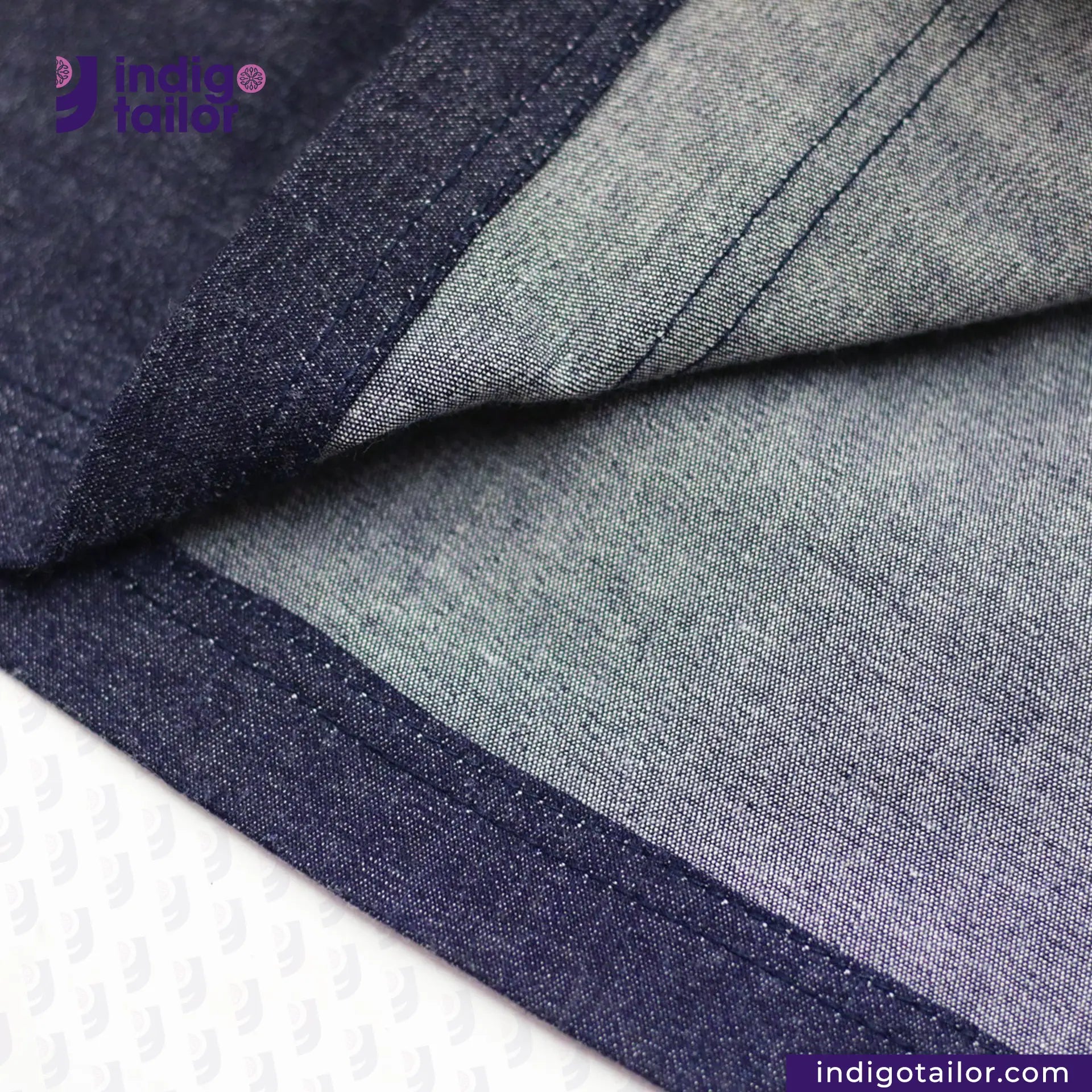 Close-up of DENIM HOODIE with 'Indigo Tailor' branding.
