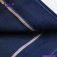 Close-up of DOUBLE DIPPED TRIPLE PLEAT REPRO fabric with red and white stitching, featuring Indigotailor logo.