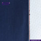 Close-up of DOUBLE DIP INDIGO SELVEDGE DENIM fabric with a visible brand logo.